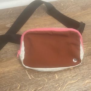 Lightly used Lululemon belt bag (not the XL version). Pink and maroon